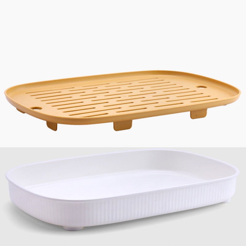 Plateau de litière et sa grille jaune séparés, vus de trois quarts